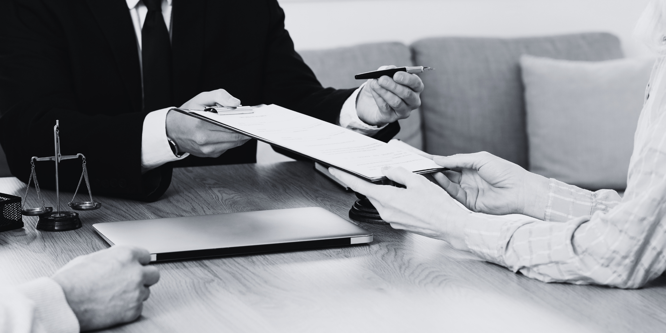 lawyer handing out a form to a client to sign. 