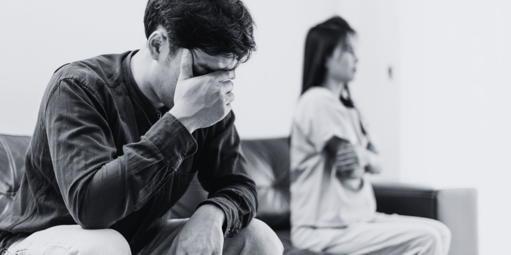 A man looking worried and sad, cover his face with his right palm.
How long does a divorce take in South Africa?