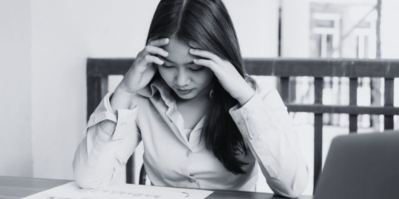 A woman sitting and looking worried