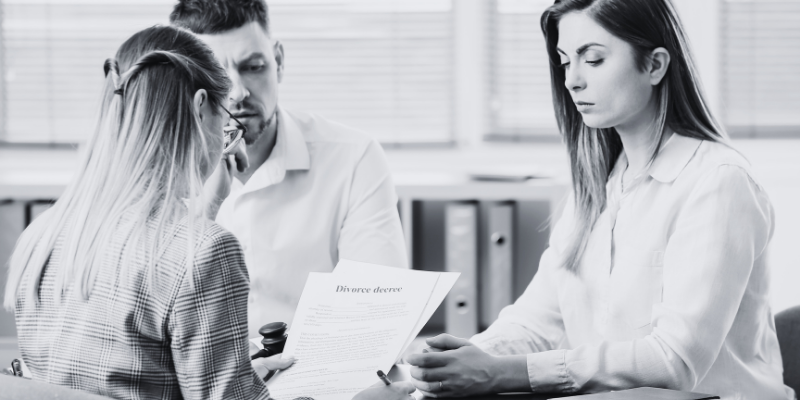 A couple speaking with a lawyer